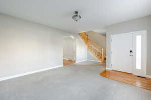 Foyer featuring light carpet