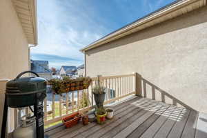 Wooden deck featuring a grill