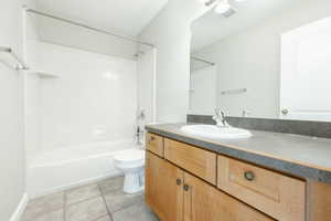 Full bathroom with tile patterned flooring, vanity, toilet, and bathing tub / shower combination