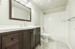 Full bathroom featuring tile patterned flooring, vanity, shower / bathtub combination, and toilet