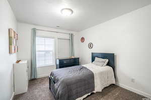 Carpeted bedroom with a textured ceiling