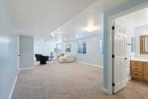 Sitting room featuring a textured ceiling and light colored carpet