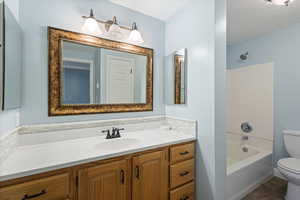 Full bathroom with tile patterned flooring, vanity,  shower combination, and toilet