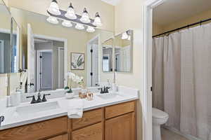 Bathroom with tile patterned floors, vanity, and toilet