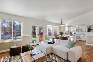 Living room featuring lofted ceiling, french doors, and dark hardwood / wood-style floors