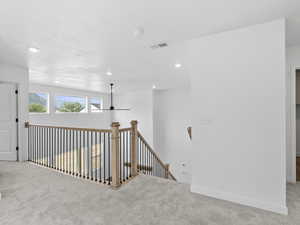 Hallway featuring carpet floors