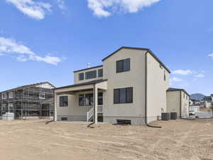 Rear view of property with central AC unit