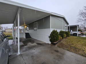 View of property exterior with a carport