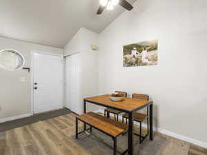 Dining space featuring hardwood / wood-style flooring, ceiling fan, and lofted ceiling