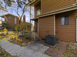 View of property exterior featuring a balcony and central AC