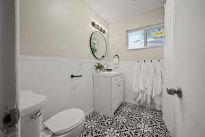 Bathroom featuring tile patterned floors, vanity, and toilet