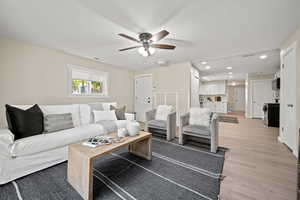 Living room featuring light hardwood / wood-style flooring and ceiling fan