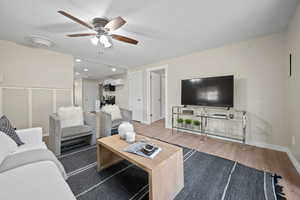 Living room featuring light wood-type flooring and ceiling fan