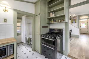 Kitchen featuring butcher block countertops, plenty of natural light, stainless steel appliances, and green cabinetry