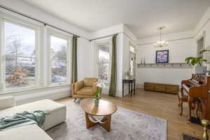 Living room with a chandelier and hardwood / wood-style flooring