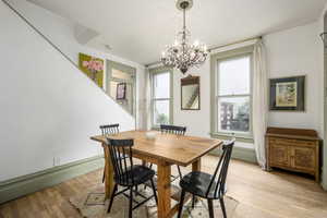 Dining space featuring an inviting chandelier and light hardwood / wood-style flooring