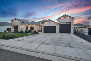 View of front of property with a yard and a garage