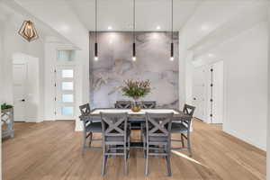 Dining space with light hardwood / wood-style flooring