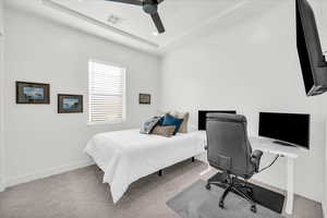 Carpeted bedroom with ceiling fan