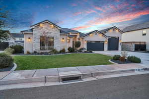 View of front of home featuring a yard and a garage