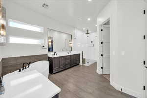 Bathroom with vanity and shower with separate bathtub