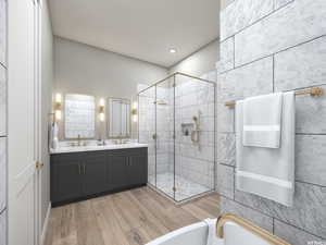 Bathroom with vanity, wood-type flooring, and plus walk in shower