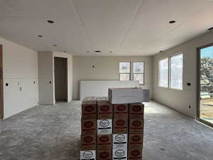 Living area featuring unfinished concrete flooring