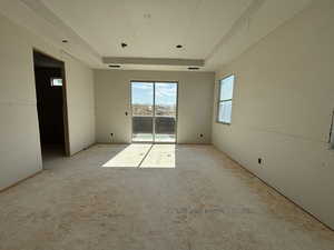 Unfurnished room with a raised ceiling