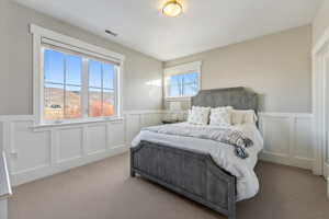 Carpeted bedroom featuring a mountain view and multiple windows