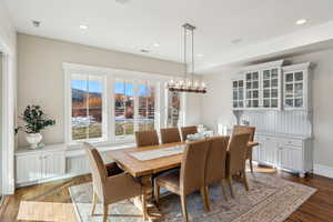 Dining area featuring dark hardwood / wood-style floors and an inviting chandelier