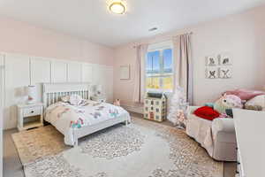 Bedroom featuring light carpet