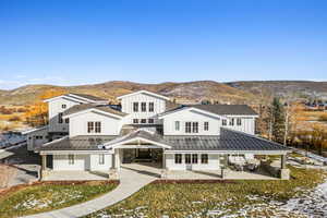 Rear view of property featuring a mountain view and a patio