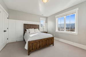 Carpeted bedroom with a mountain view