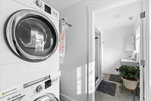 Washroom featuring stacked washer and dryer