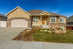 View of front of house featuring a garage and a front lawn