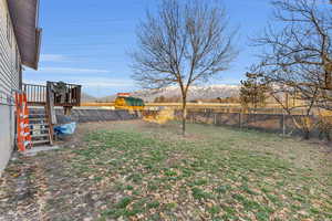 View of yard featuring a deck with mountain view