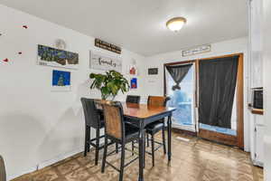 Dining area featuring a textured ceiling