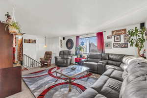 Carpeted living room with a textured ceiling