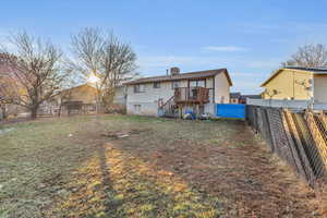 Back of property featuring a yard