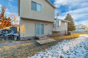 Snow covered house featuring central AC