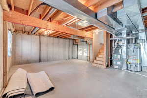 Basement featuring strapped water heater