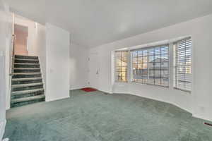 Unfurnished living room with dark carpet