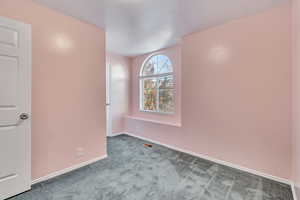 Empty room featuring carpet flooring