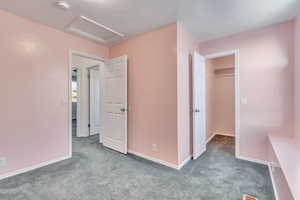 Unfurnished bedroom featuring light colored carpet and a closet