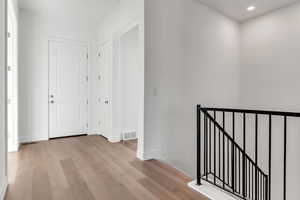 Corridor featuring light hardwood / wood-style flooring