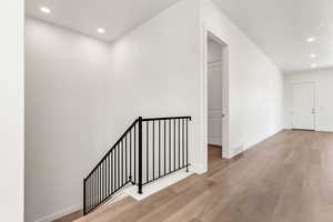 Hallway with light hardwood / wood-style flooring