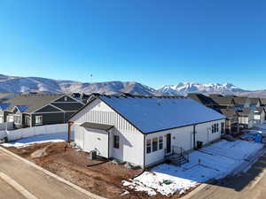 View of front of house featuring central air condition unit and a mountain view