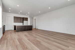 Unfurnished living room featuring light wood-type flooring