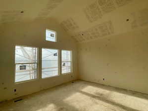 Primary Bedroom with oversized windows and vaulted ceiling.