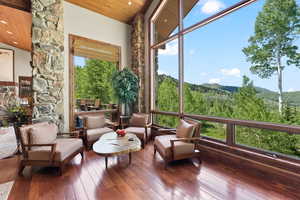 Sunroom / solarium featuring a mountain view, vaulted ceiling, and wood ceiling